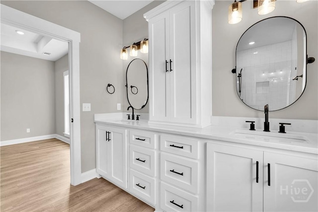 1362 Ebenezer Rd, Rincon, GA 31326 - bathroom featuring double vanity, wood finished floors, baseboards, and tiled shower