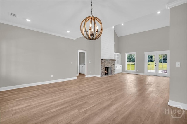 1362 Ebenezer Rd, Rincon, GA 31326 - unfurnished living room featuring baseboards, a chandelier, high vaulted ceiling, ornamental molding, and light wood-style flooring