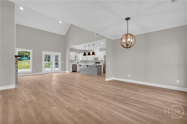 1362 Ebenezer Rd, Rincon, GA 31326 - unfurnished living room featuring a chandelier, baseboards, light wood finished floors, high vaulted ceiling, and recessed lighting
