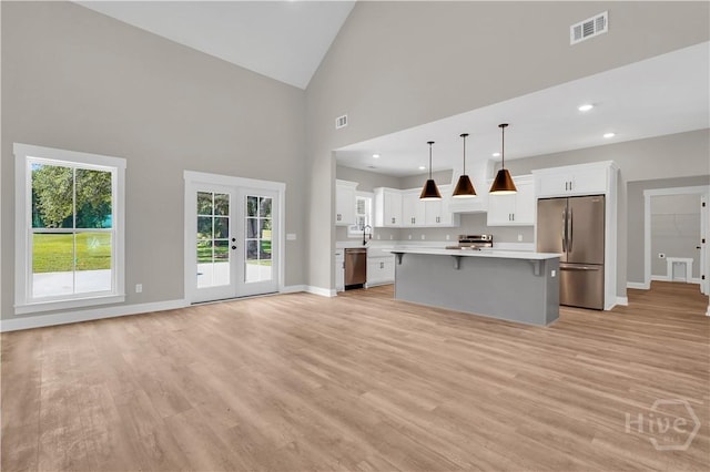 1362 Ebenezer Rd, Rincon, GA 31326 - kitchen featuring appliances with stainless steel finishes, light countertops, french doors, a breakfast bar, and a kitchen island