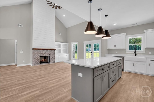 1362 Ebenezer Rd, Rincon, GA 31326 - kitchen with high vaulted ceiling, gray cabinets, a sink, light countertops, and white cabinets
