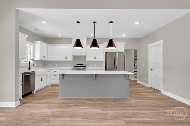 1362 Ebenezer Rd, Rincon, GA 31326 - kitchen with appliances with stainless steel finishes, a kitchen island, light countertops, white cabinetry, and recessed lighting
