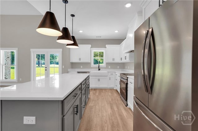 1362 Ebenezer Rd, Rincon, GA 31326 - kitchen with stainless steel appliances, gray cabinetry, light wood-style floors, light countertops, and a center island