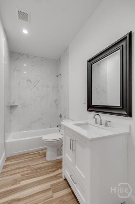 238-A W Magnolia Ave, Savannah, GA 31419 - bathroom with vanity, toilet, shower / washtub combination, wood finished floors, and recessed lighting