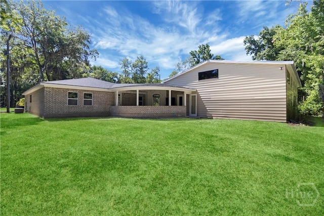 238-A W Magnolia Ave, Savannah, GA 31419 - back of house featuring a lawn and brick siding