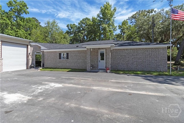 238-A W Magnolia Ave, Savannah, GA 31419 - view of front of property with brick siding, asphalt driveway, and an attached garage