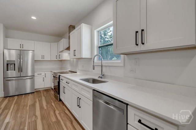 238-A W Magnolia Ave, Savannah, GA 31419 - kitchen with stainless steel appliances, a sink, white cabinetry, light wood finished floors, and light countertops