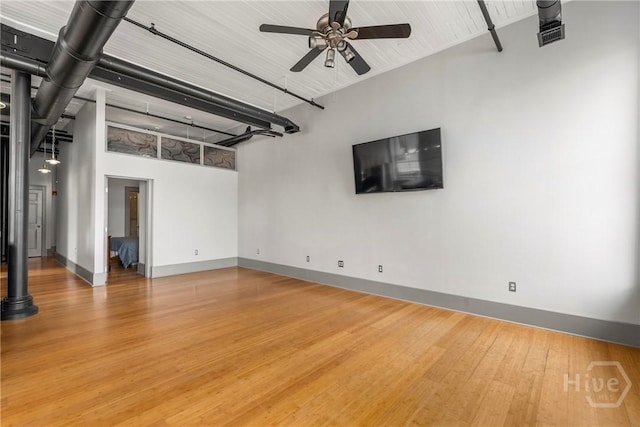 301 W Broughton St Unit 3B, Savannah, GA 31401 - unfurnished living room featuring a ceiling fan, baseboards, and wood finished floors