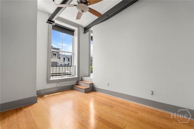 301 W Broughton St Unit 3B, Savannah, GA 31401 - empty room featuring beamed ceiling, ceiling fan, wood finished floors, and baseboards