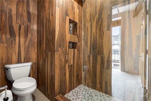 301 W Broughton St Unit 3B, Savannah, GA 31401 - bathroom featuring toilet, tiled shower, and tile walls