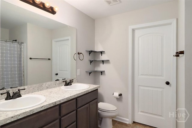 304 Boomer Ct, Guyton, GA 31312 - bathroom featuring double vanity, toilet, tile patterned flooring, and baseboards