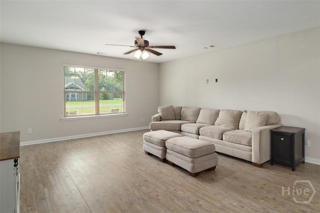 304 Boomer Ct, Guyton, GA 31312 - living area with ceiling fan, light wood finished floors, and baseboards