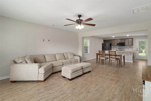 304 Boomer Ct, Guyton, GA 31312 - living room with light wood-style flooring, baseboards, a ceiling fan, and recessed lighting