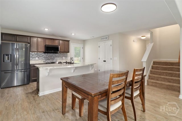304 Boomer Ct, Guyton, GA 31312 - dining space featuring light wood-style flooring, stairway, and recessed lighting