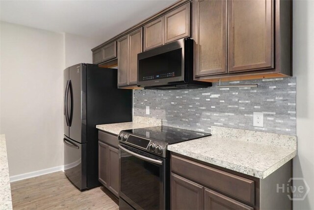 304 Boomer Ct, Guyton, GA 31312 - kitchen with electric stove, baseboards, light countertops, and light wood-type flooring
