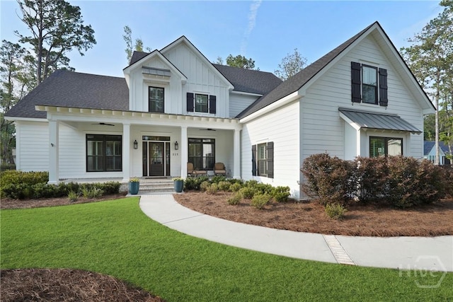 315 Linkside Lake Dr, Richmond Hill, GA 31324 - modern farmhouse featuring ceiling fan, a front yard, a porch, board and batten siding, and a standing seam roof
