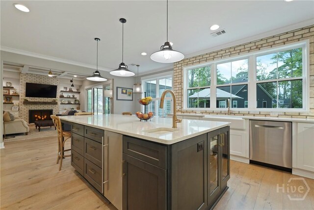 315 Linkside Lake Dr, Richmond Hill, GA 31324 - kitchen with dishwasher, a sink, a fireplace, light wood-type flooring, and crown molding