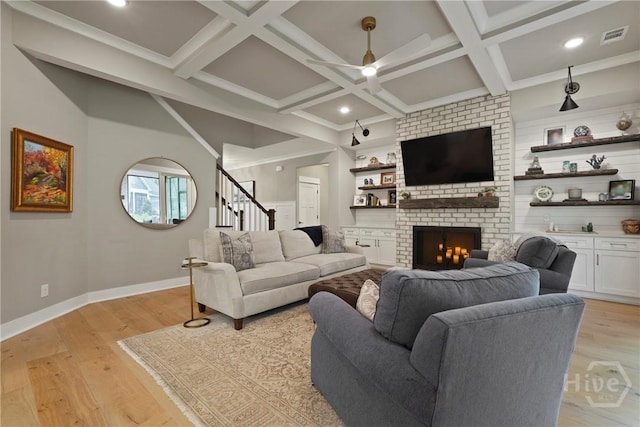 315 Linkside Lake Dr, Richmond Hill, GA 31324 - living area featuring baseboards, ceiling fan, a brick fireplace, coffered ceiling, and light wood-style flooring