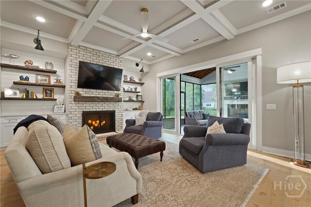 315 Linkside Lake Dr, Richmond Hill, GA 31324 - living area featuring a ceiling fan, light wood finished floors, a brick fireplace, coffered ceiling, and beam ceiling