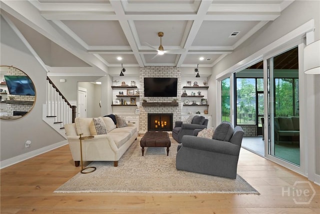 315 Linkside Lake Dr, Richmond Hill, GA 31324 - living area featuring a ceiling fan, wood-type flooring, a fireplace, beamed ceiling, and baseboards