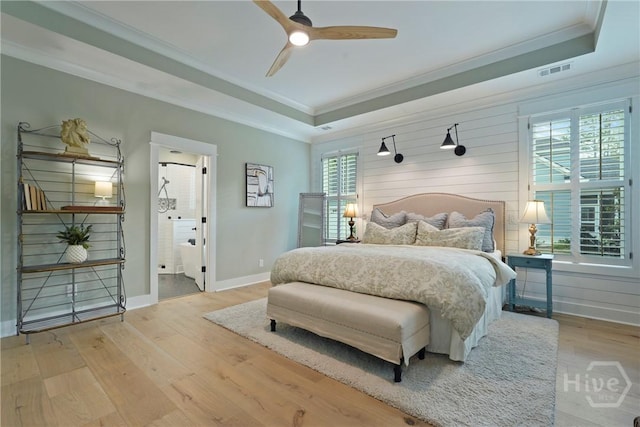 315 Linkside Lake Dr, Richmond Hill, GA 31324 - bedroom with a tray ceiling, crown molding, wood finished floors, baseboards, and a ceiling fan