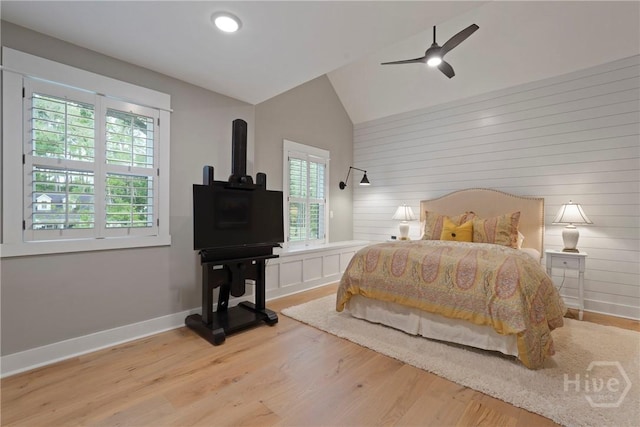 315 Linkside Lake Dr, Richmond Hill, GA 31324 - bedroom with multiple windows, wood finished floors, vaulted ceiling, baseboards, and wooden walls