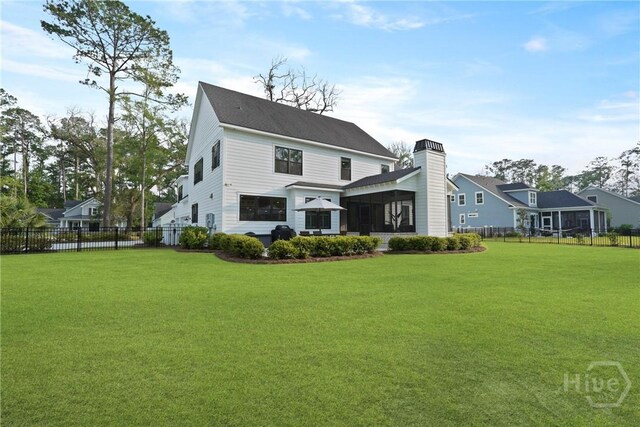 315 Linkside Lake Dr, Richmond Hill, GA 31324 - rear view of house featuring a sunroom and a chimney