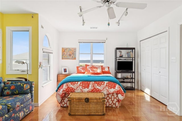 5 Northshore Dr, Tybee Island, GA 31328 - tiled bedroom with rail lighting, a closet, and ceiling fan