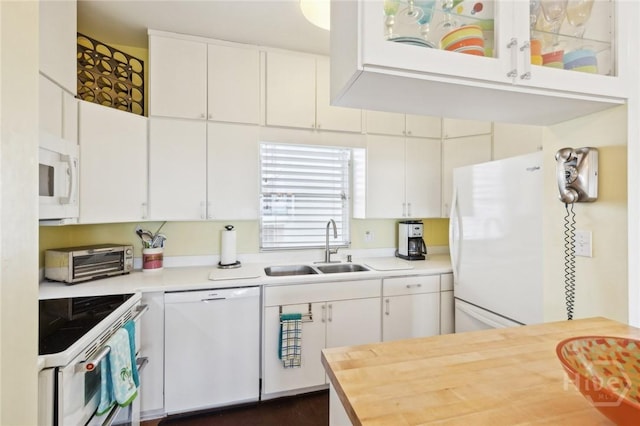 5 Northshore Dr, Tybee Island, GA 31328 - kitchen with white appliances, a sink, white cabinetry, and wooden counters
