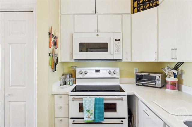 5 Northshore Dr, Tybee Island, GA 31328 - kitchen with white appliances, light countertops, and white cabinets