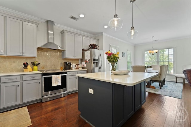 20 Oakcrest Ct, Savannah, GA 31405 - kitchen featuring wall chimney exhaust hood, stainless steel appliances, gray cabinets, ornamental molding, and dark wood-style floors