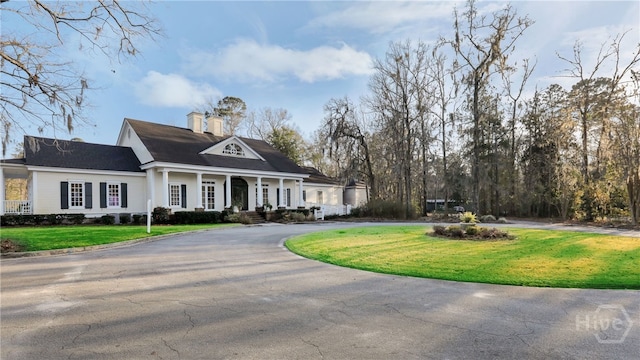 20 Oakcrest Ct, Savannah, GA 31405 - neoclassical / greek revival house featuring curved driveway, a porch, a front yard, and a chimney