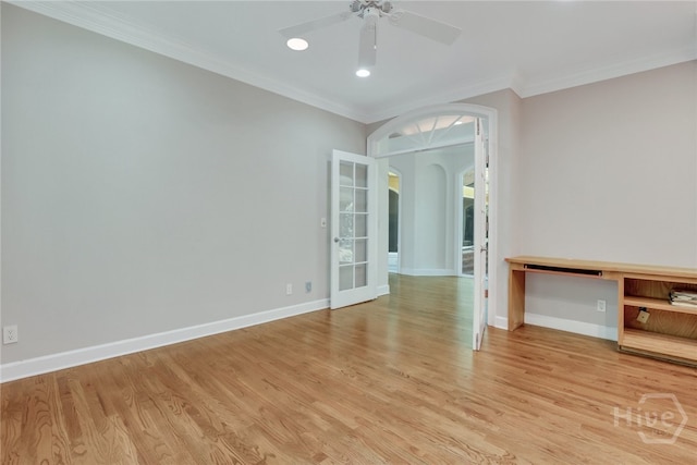 3 Elcy Ln, Savannah, GA 31411 - unfurnished room with arched walkways, light wood-style floors, baseboards, a ceiling fan, and crown molding