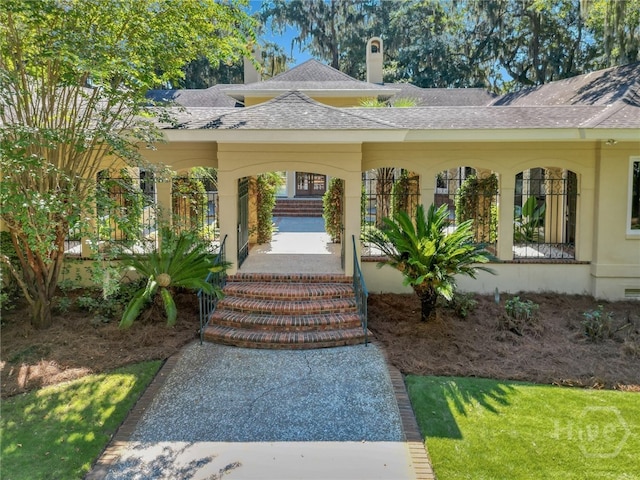 3 Elcy Ln, Savannah, GA 31411 - entrance to property featuring a shingled roof and a chimney