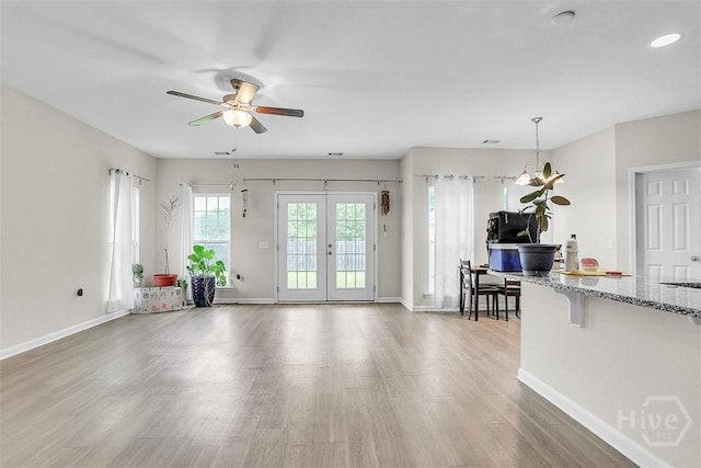 194 Calm Oaks Cir, Savannah, GA 31419 - living room with wood finished floors, ceiling fan, baseboards, and french doors