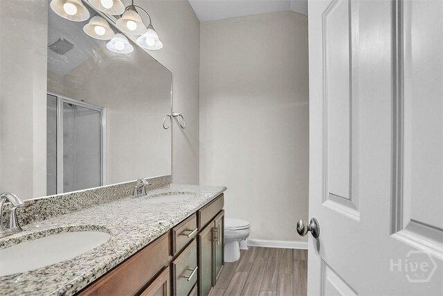 194 Calm Oaks Cir, Savannah, GA 31419 - full bathroom featuring toilet, a stall shower, baseboards, double vanity, and wood finished floors