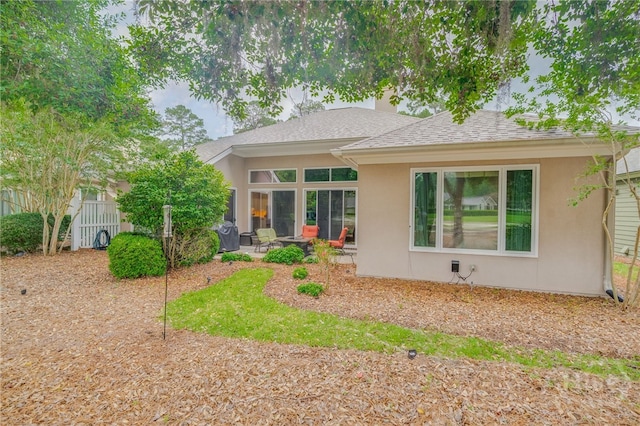 6 Pine Shadow Ct, Savannah, GA 31411 - back of property featuring stucco siding, a patio, roof with shingles, and a chimney