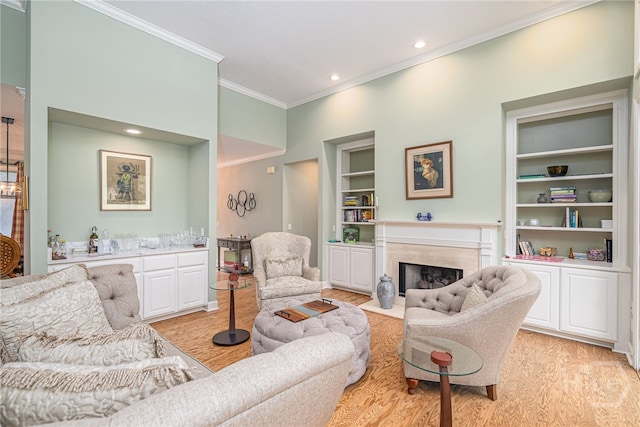 6 Pine Shadow Ct, Savannah, GA 31411 - living area with ornamental molding, built in features, light wood-style flooring, a high end fireplace, and bar with sink
