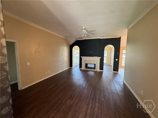415 Copper Creek Cir, Pooler, GA 31322 - unfurnished living room with arched walkways, a ceiling fan, healthy amount of natural light, dark wood-style flooring, and ornamental molding
