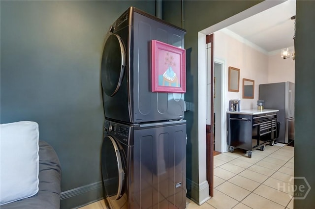 123 W Park Ave Unit 2, Savannah, GA 31401 - laundry area featuring stacked washer / drying machine, a chandelier, light tile patterned flooring, and crown molding