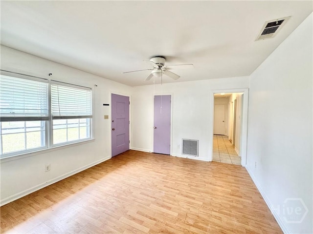 5 Ossabaw Rd, Savannah, GA 31410 - unfurnished living room featuring light wood-type flooring, a ceiling fan, and baseboards
