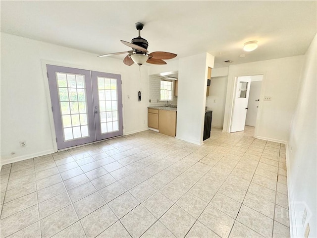 5 Ossabaw Rd, Savannah, GA 31410 - unfurnished living room featuring french doors, light tile patterned floors, a ceiling fan, a sink, and baseboards