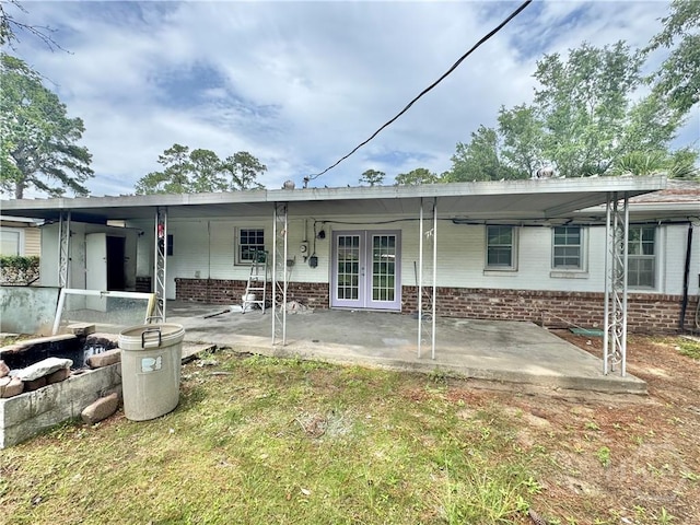 5 Ossabaw Rd, Savannah, GA 31410 - back of property with french doors, a patio, and brick siding