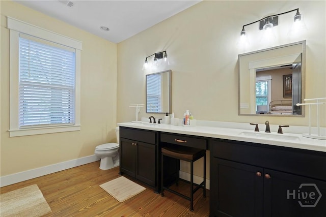 39 Bird Dog Ln, Midway, GA 31320 - bathroom with double vanity, wood finished floors, toilet, and baseboards