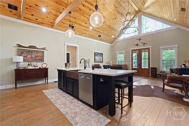 39 Bird Dog Ln, Midway, GA 31320 - kitchen with stainless steel dishwasher, open floor plan, wooden ceiling, dark cabinetry, and light countertops