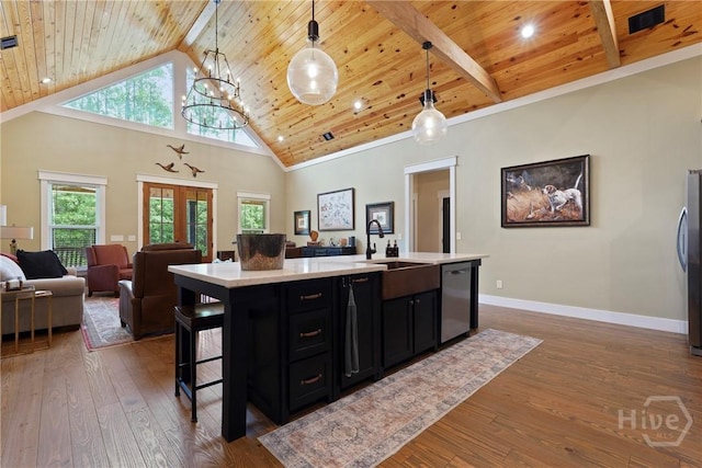 39 Bird Dog Ln, Midway, GA 31320 - kitchen with appliances with stainless steel finishes, dark cabinetry, wooden ceiling with exposed beams, a sink, and light countertops