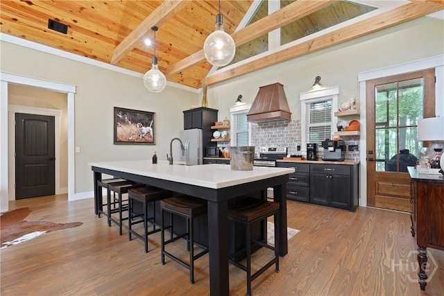 39 Bird Dog Ln, Midway, GA 31320 - kitchen with custom range hood, wooden ceiling, open shelves, backsplash, and a kitchen bar