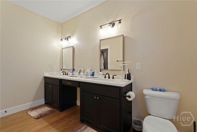39 Bird Dog Ln, Midway, GA 31320 - bathroom with wood finished floors, double vanity, toilet, and baseboards