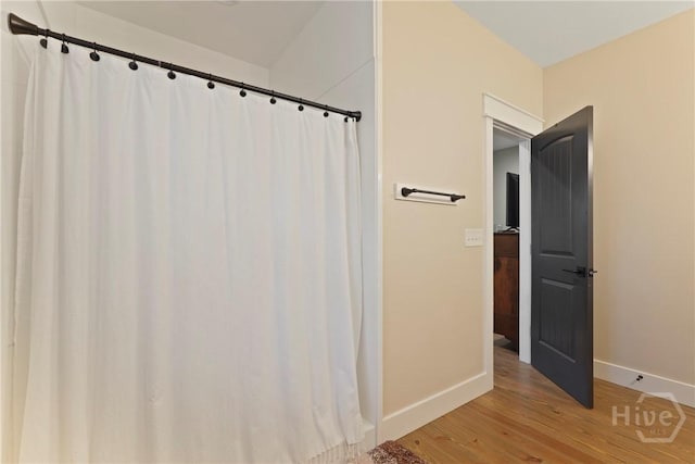 39 Bird Dog Ln, Midway, GA 31320 - bathroom featuring baseboards, wood finished floors, and a shower with curtain