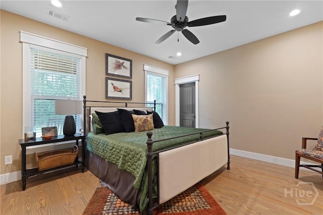 39 Bird Dog Ln, Midway, GA 31320 - bedroom with baseboards, multiple windows, light wood-style floors, recessed lighting, and ceiling fan